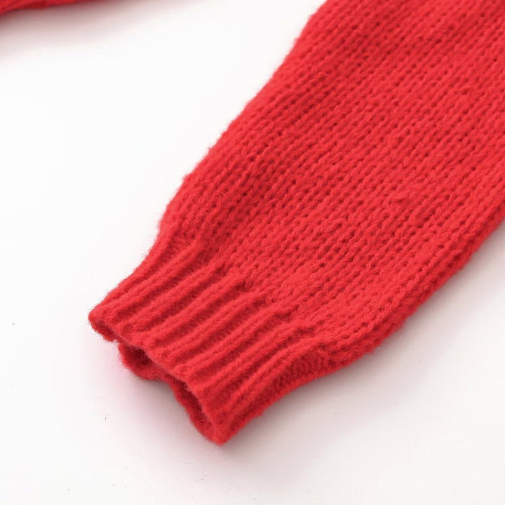 Women’s chunky knit oversized pullover with short stand-up collar and decorative knot detail