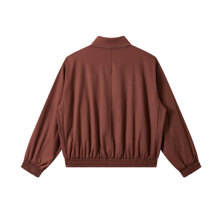 Men's short cut boxy blouson with high stand-up collar, elastic hem and zipper front.