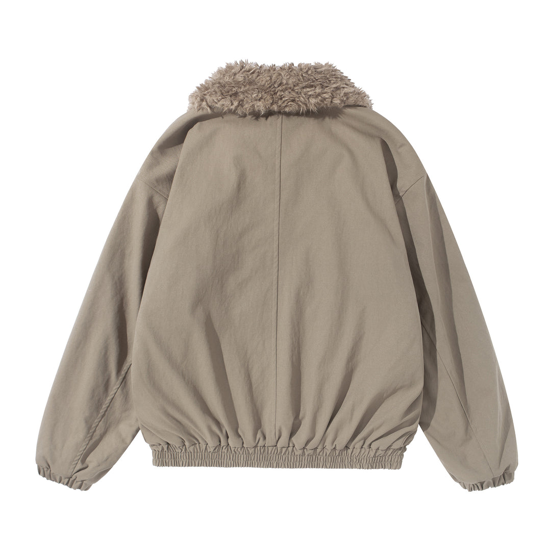 Women's short jacket with voluminous faux fur collar, kangaroo pockets, and elastic hem Mune Fashion