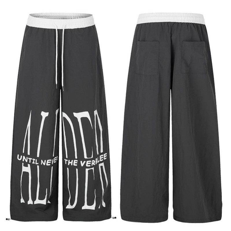 Women's wide loungewear pants with high comfort waistband, drawstring, adjustable hem, and typographic print Mune Fashion