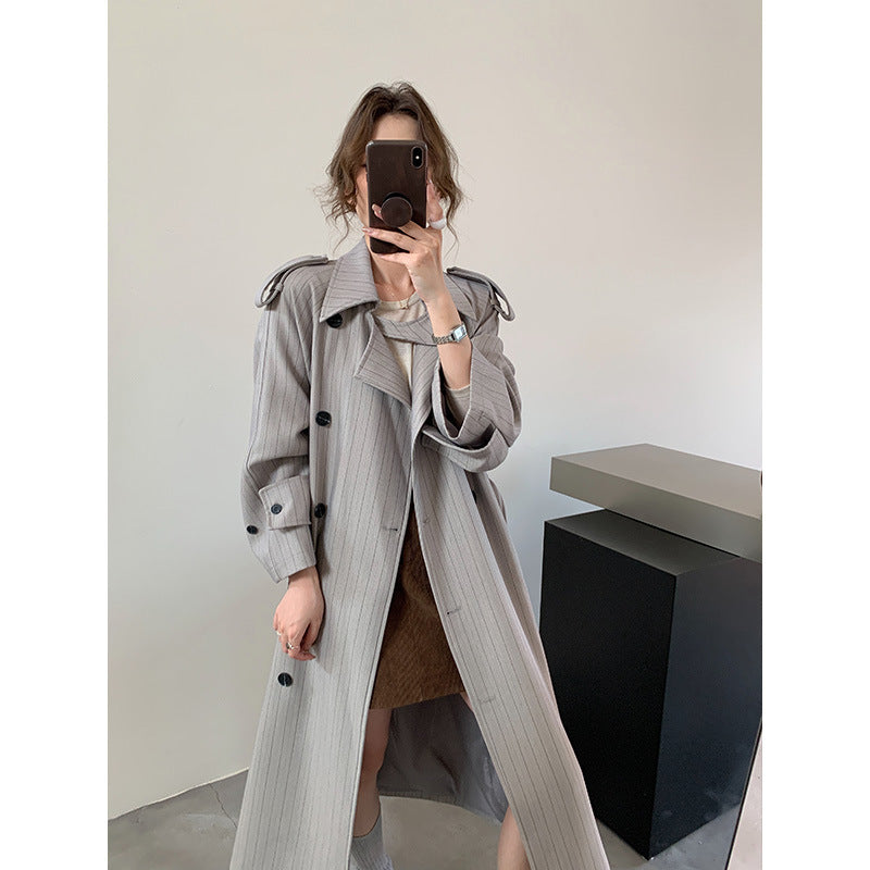Women's pinstripe trench coat with boxy silhouette, shoulder patches, and concealed tie belt Mune Fashion