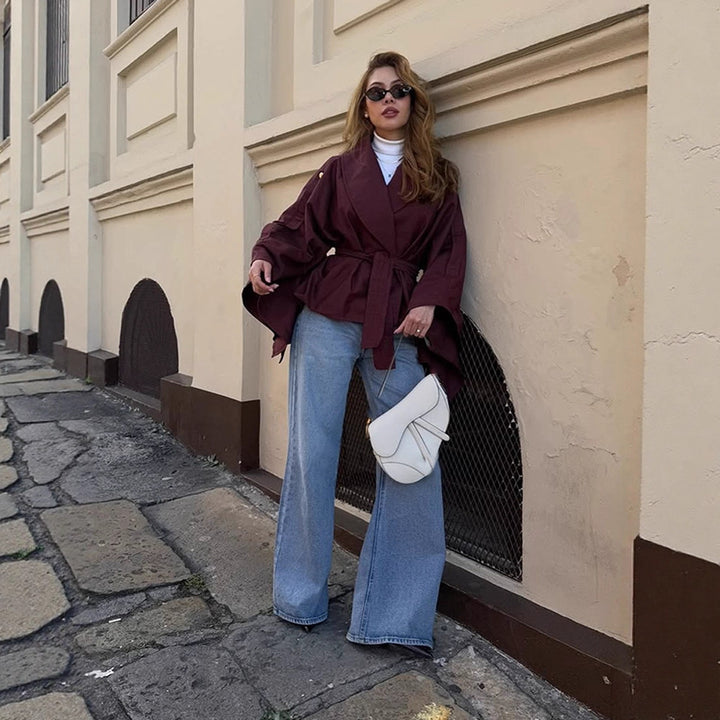 Women's short trench-style jacket with belted waist, oversized sleeves, and boxy cropped silhouette Mune Fashion