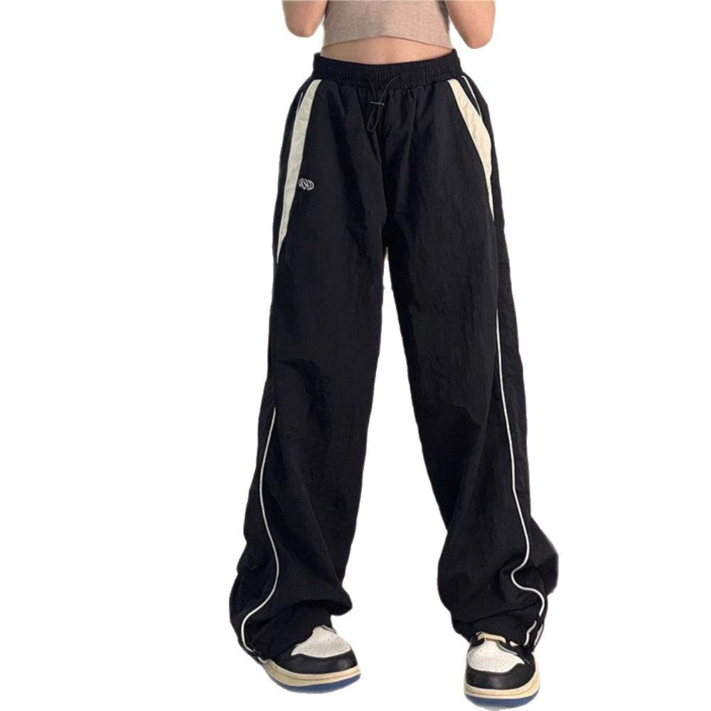Women's wide track pants with contrast piping, elastic waistband and oversized fit Mune Fashion