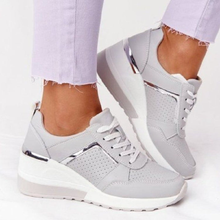 Women's wedge sneakers with perforated upper material, padded comfort collar and reflective metal details Mune Fashion