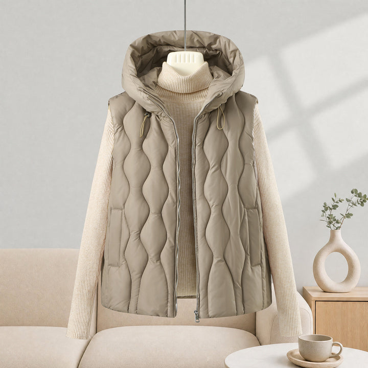 Women longer cut quilted vest with hood, wave quilting and detachable zipper Mune Fashion
