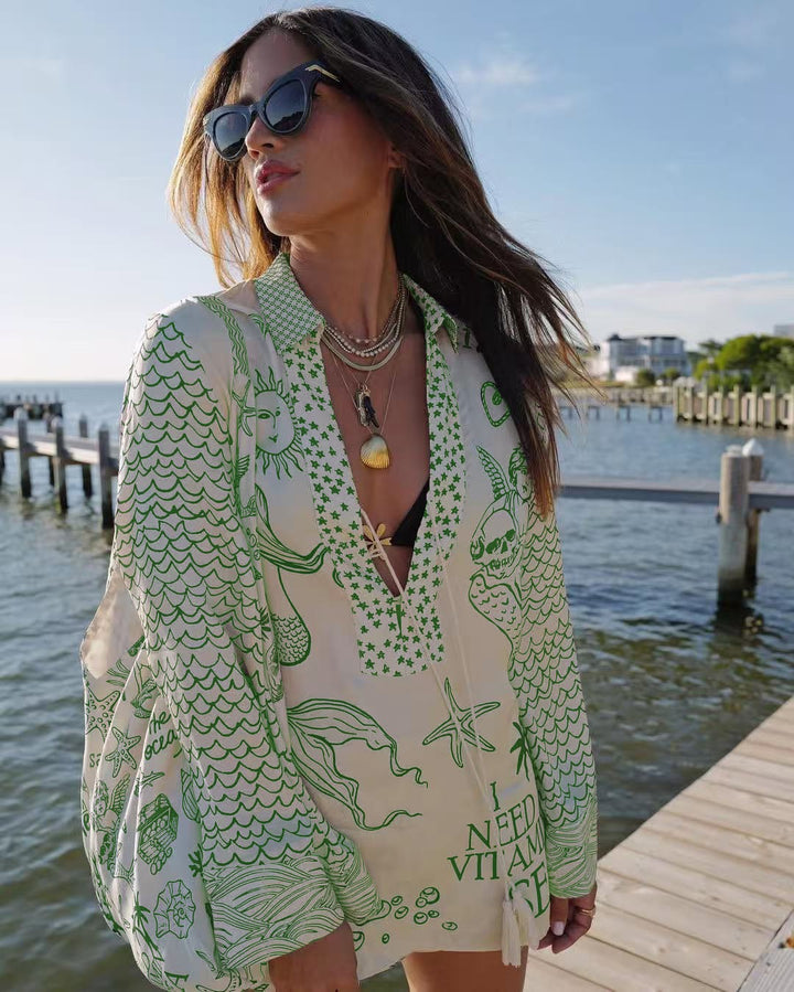 Ladies lightweight beach cover-up in tunic form with deep V-neck, tassel closure, and nautical ocean print Mune Fashion