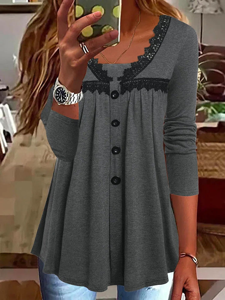 Women's A-line tunic shirt with button placket, lace yoke insert, and gathered empire seam
