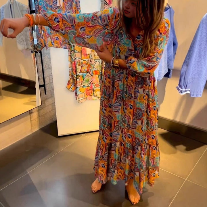 Women's tiered maxi dress in boho style with paisley print, V-neck, gathered empire waist and elastic cuffs Mune Fashion