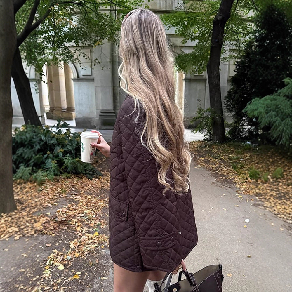Women's oversized quilted jacket in coat style with snap button placket and patch flap pockets Mune Fashion