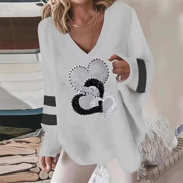 Women's oversized knitted sweater with deep neckline sequin heart and contrast sleeve stripes Mune Fashion