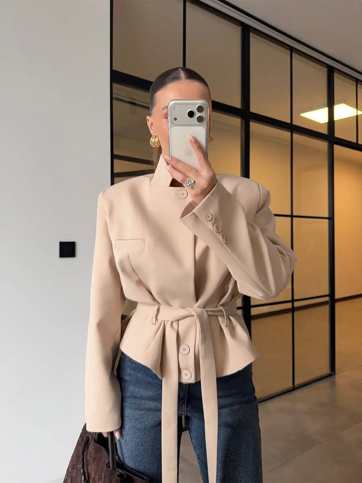 Women's tailored short blazer with standing collar, peplum, and tie belt Mune Fashion