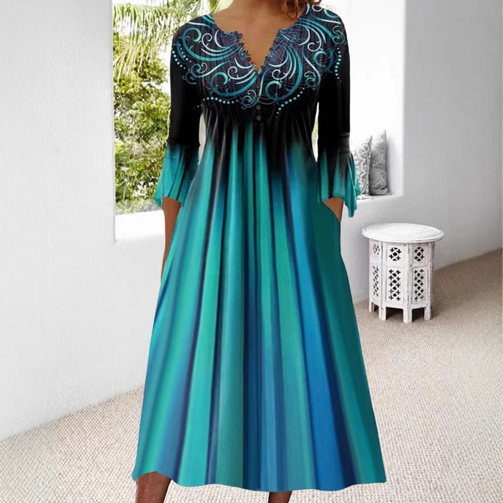 Women's flowing maxi dress with embellished V-neck, underbust seam, flared skirt and side pockets Mune Fashion