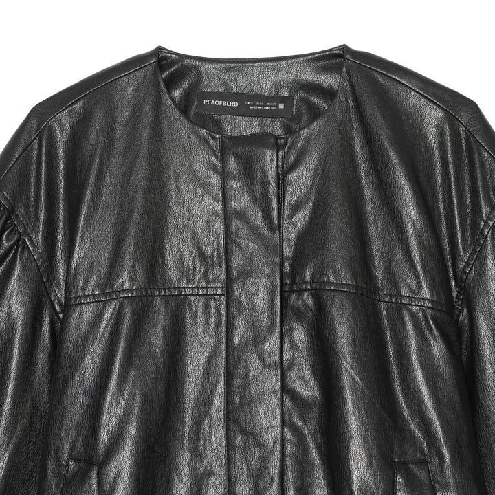 Women's short blouson in leather look with round neck, concealed snap button placket and balloon sleeves Mune Fashion
