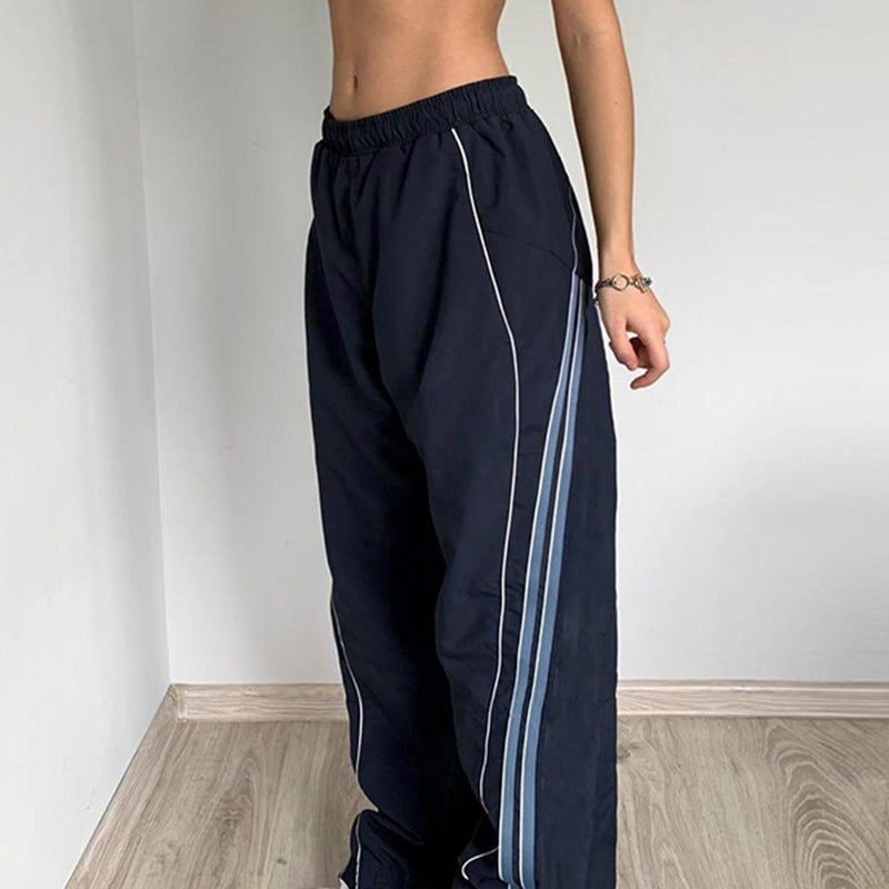 Ladies' sporty training pants with straight leg, elastic comfort waistband, and decorative side piping Mune Fashion