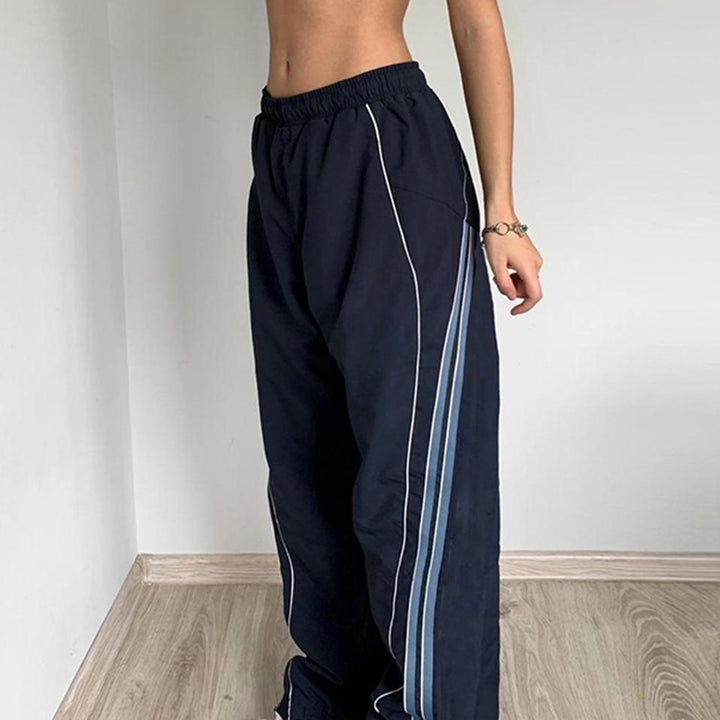 Ladies' sporty training pants with straight leg, elastic comfort waistband, and decorative side piping Mune Fashion