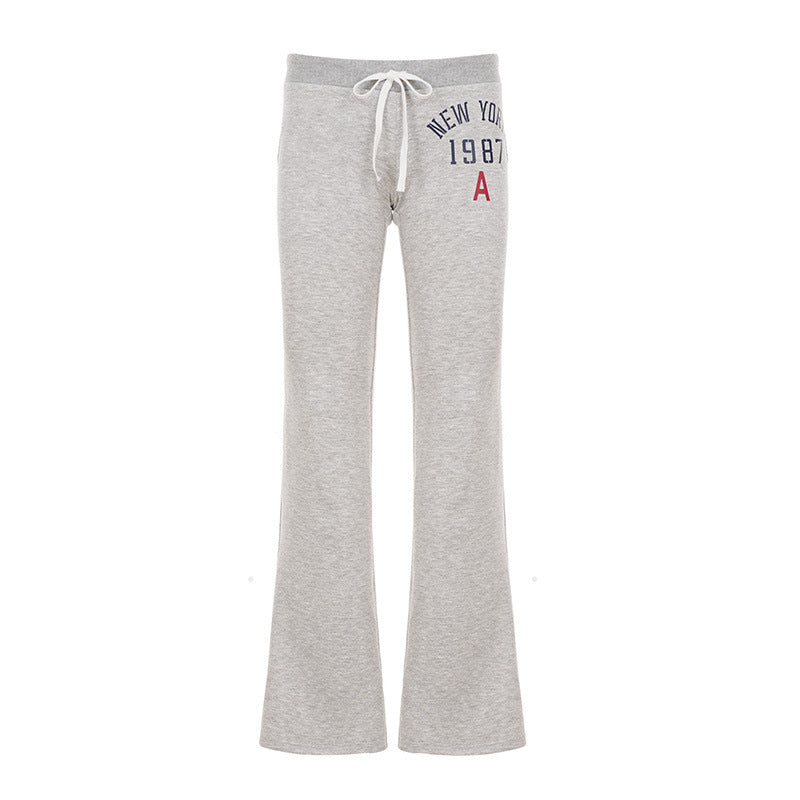 Women's soft flared jogging pants with drawstring, side pockets, and eye-catching Love print Mune Fashion