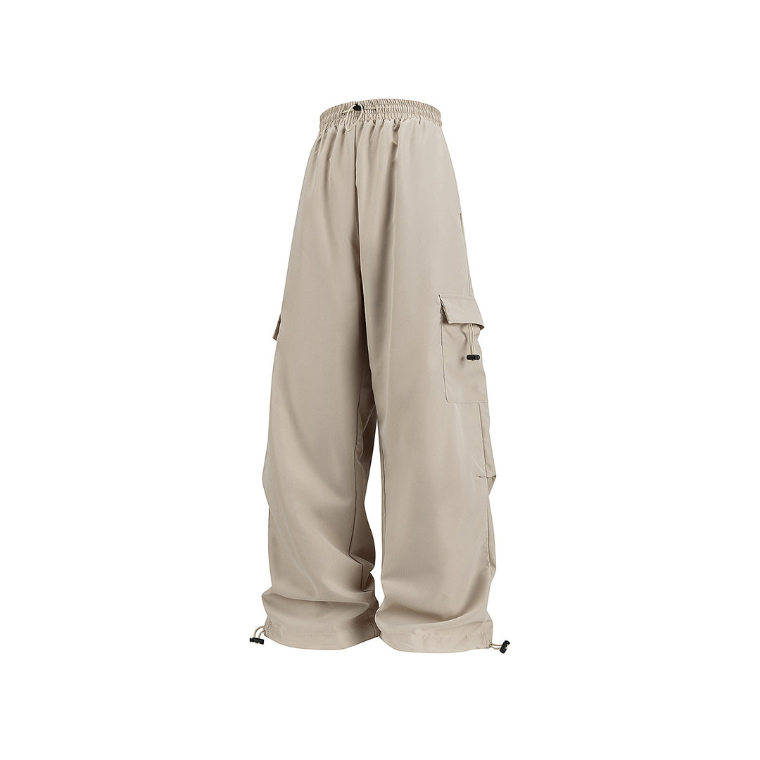 Men's wide technical cargo pants with drawstring waistband, multiple pockets and corded closure Drune
