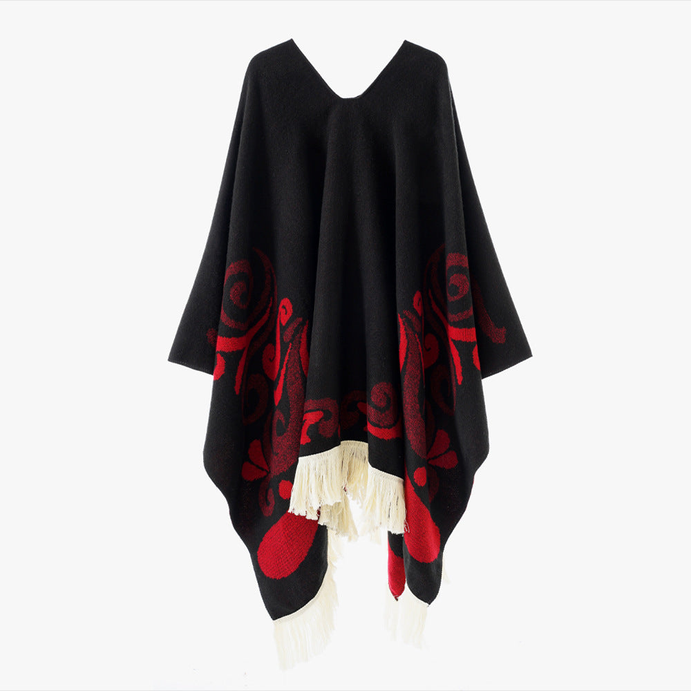 Women's wool blend poncho in cape style with V-neck, contrasting ornament jacquard and fringes.