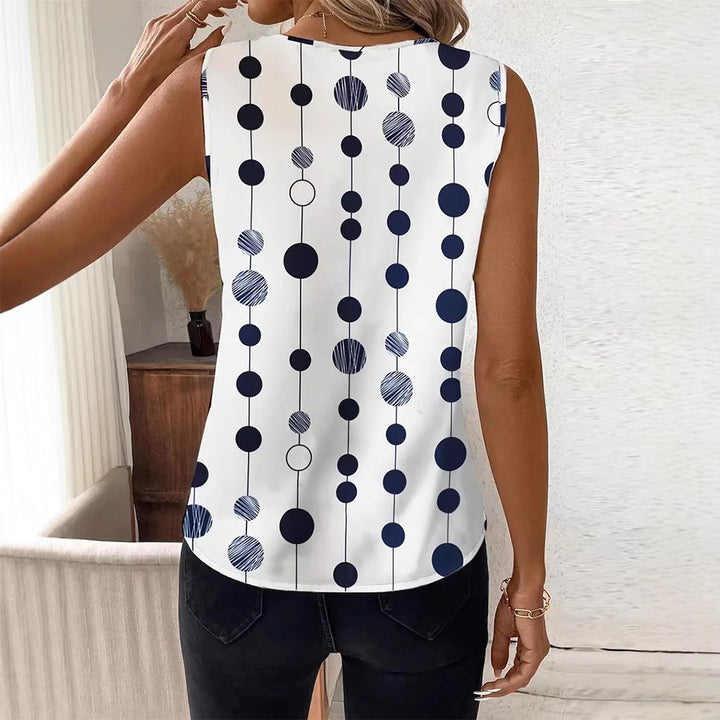 Women's V-neck blouse top with vertical polka dot pattern and subtle center seam Mune Fashion