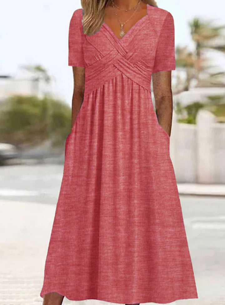Women's airy V-neck midi dress with crossed bodice, short sleeves, and side pockets Mune Fashion