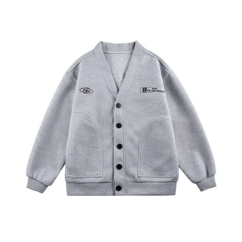 Unisex Boxy knit cardigan in waffle knit with V-neck, continuous button placket, and applied round pockets Mune Fashion