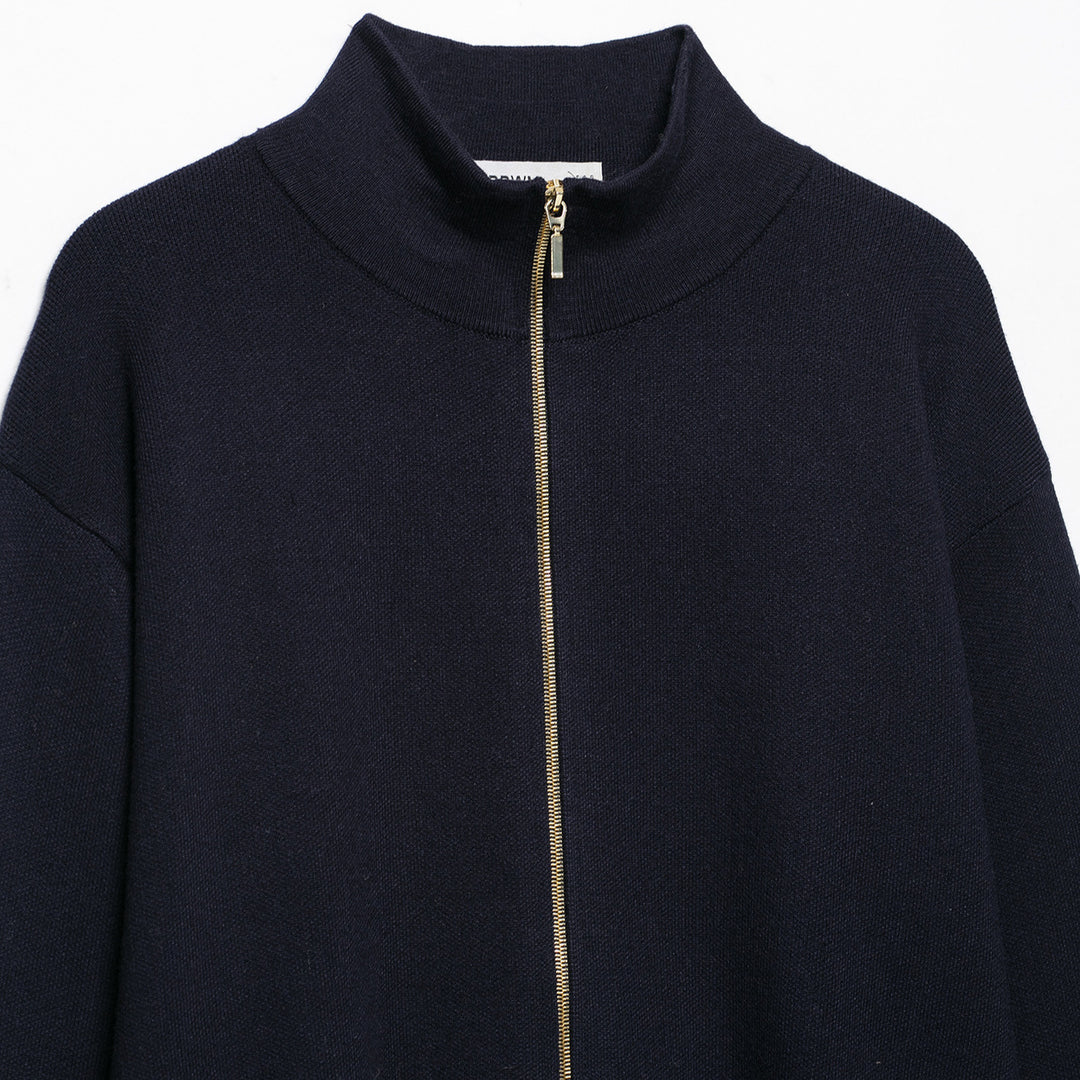 Women's cropped fine-knit cardigan with standing collar, full-length zipper, and fitted ribbed section.