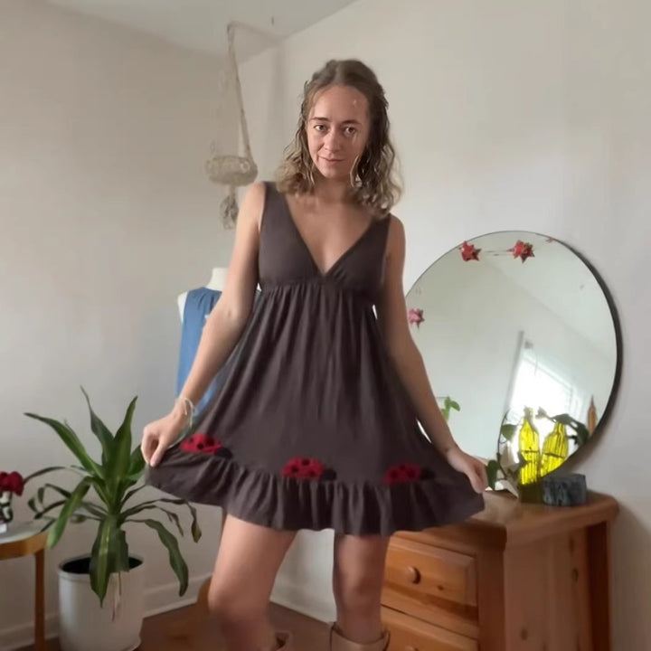 Women's sleeveless mini dress with deep V-neck underbust seam and ruffle hem with ladybug appliqué Mune Fashion