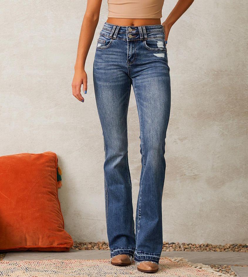 Ladies high-waisted vintage bootcut jeans with double button fly, light destroyed detail, and frayed hem Mune Fashion