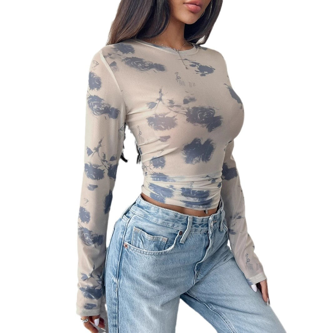 Women's form-fitting tailored crop mesh top with round neck, extended sleeves, thumb holes, and subtle tie-dye pattern Mune Fashion
