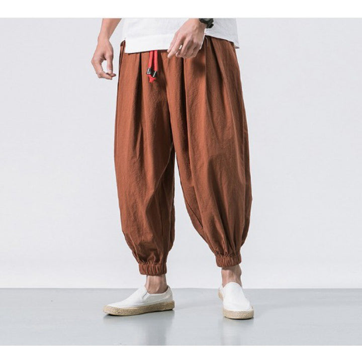 Men's wide-cut harem pants with low crotch, elastic waistband, and decorative drawstring Mune Fashion