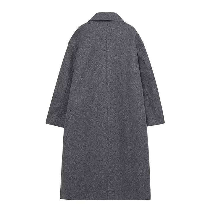 Women’s long cut boxy coat with double-breasted front, overlapping shawl collar, and generous flap pockets Mune Fashion