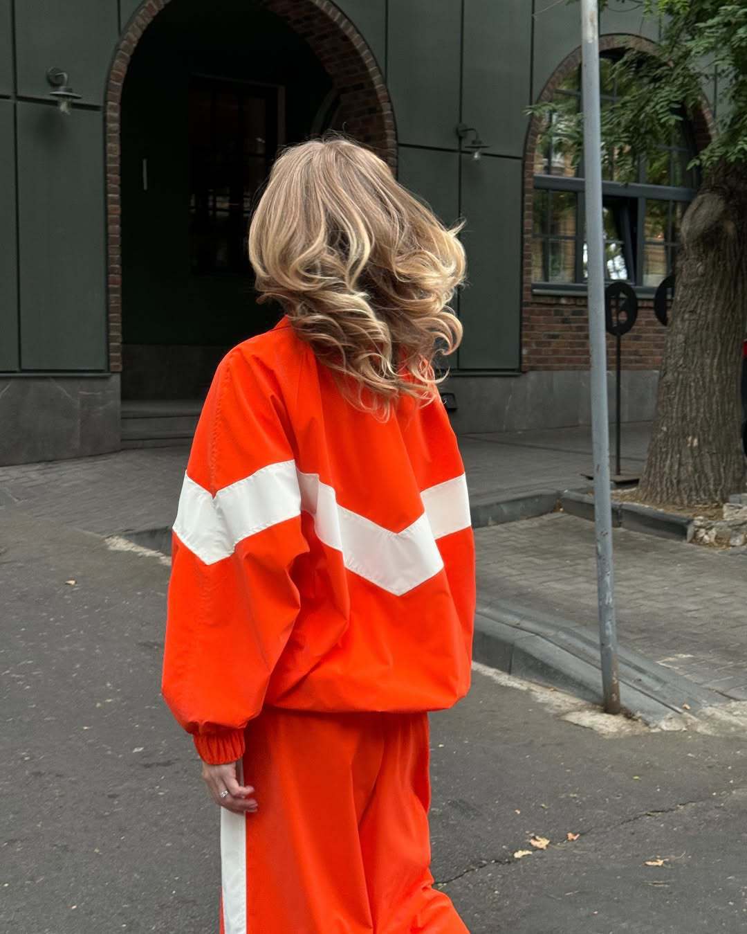 Women's lightweight oversized windbreaker jacket with contrast panels, drawstring hem, and elastic cuffs