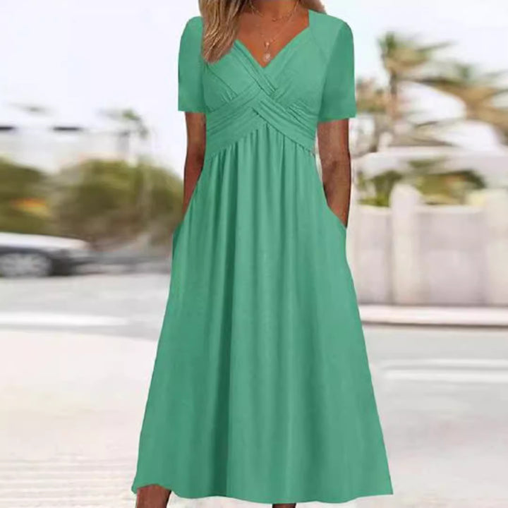Women's flowing maxi dress with crossed yoke V-neck short sleeves and side pockets Mune Fashion