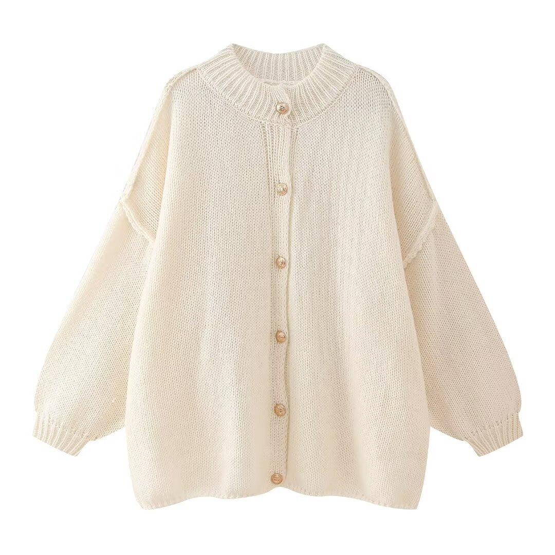Women’s oversized knit cardigan made of chunky knit with ribbed round neck, dropped shoulders, and wooden button placket.