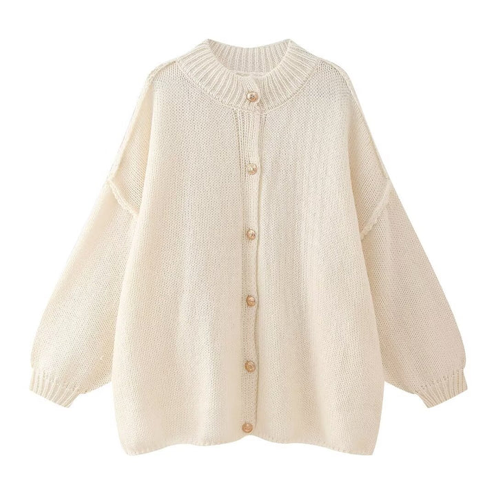 Women’s oversized knit cardigan made of chunky knit with ribbed round neck, dropped shoulders, and wooden button placket.