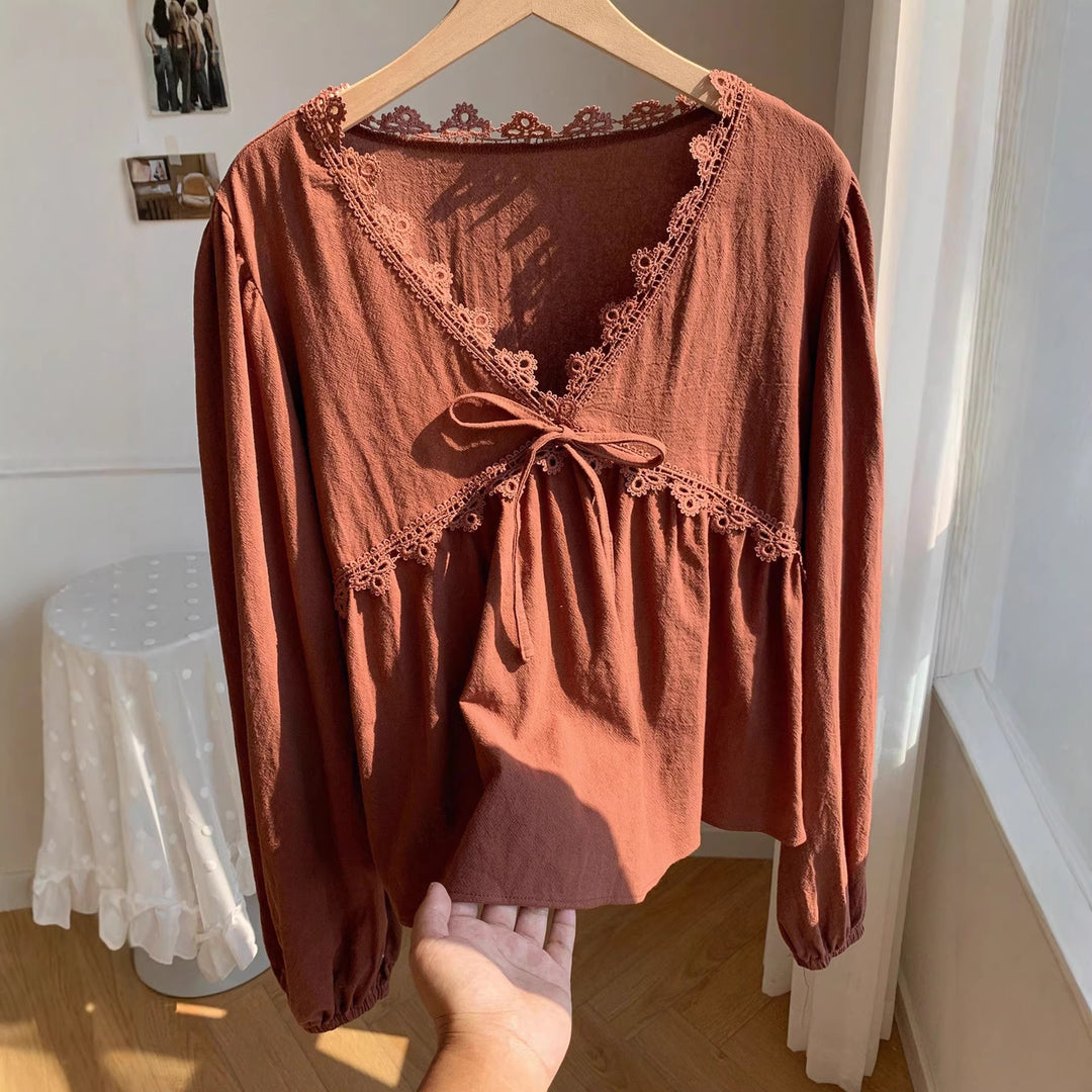 Women’s short blouse with empire cut, V-neck, lace trim, and tie bow Mune Fashion