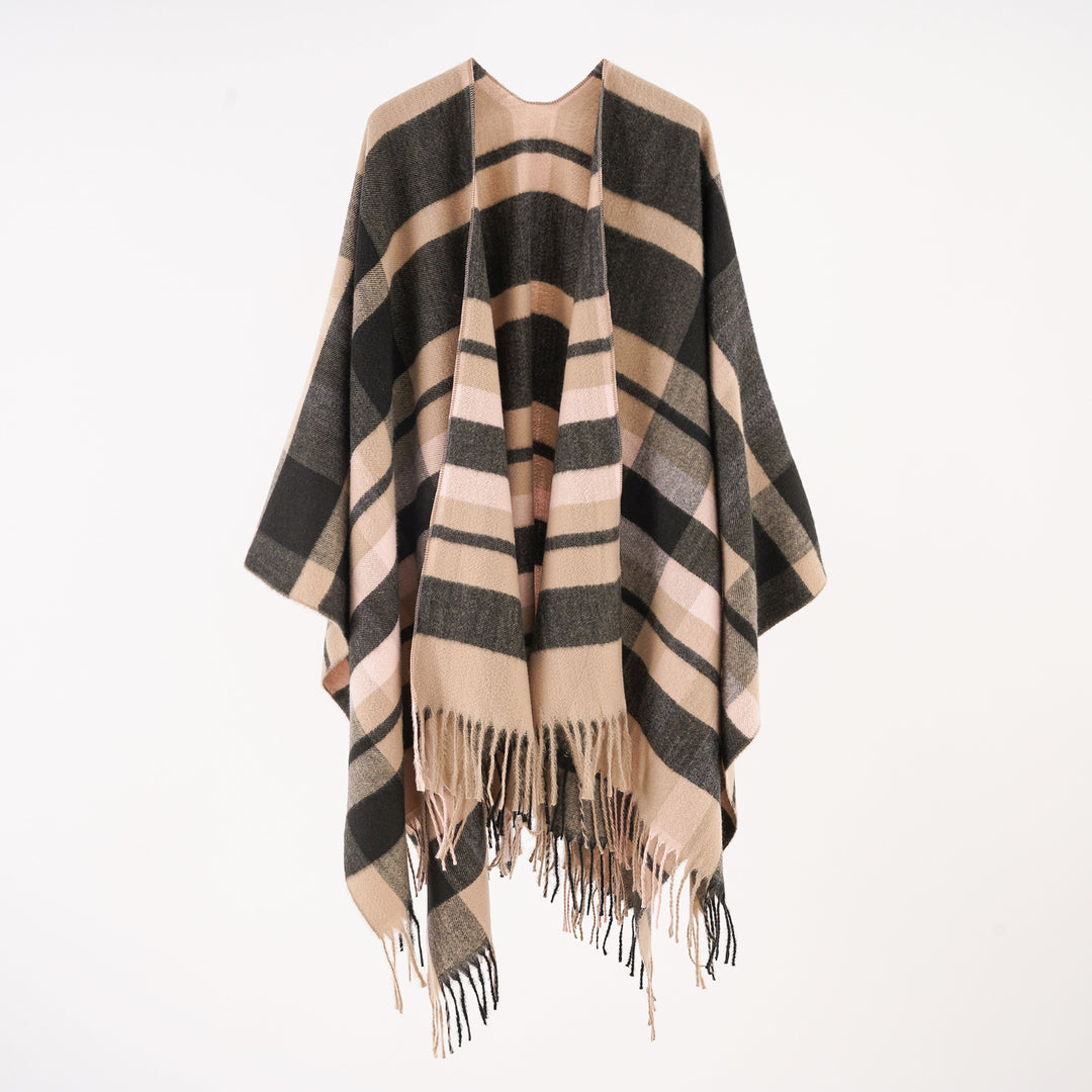 Women's wool blend ruana in boxy oversized with large check pattern and fringed hem.