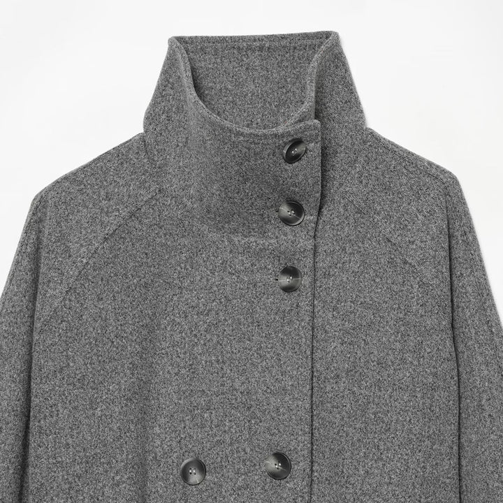 Women's cape transitional jacket in a short cut with a high collar, double button placket, and waist tie belt Mune Fashion