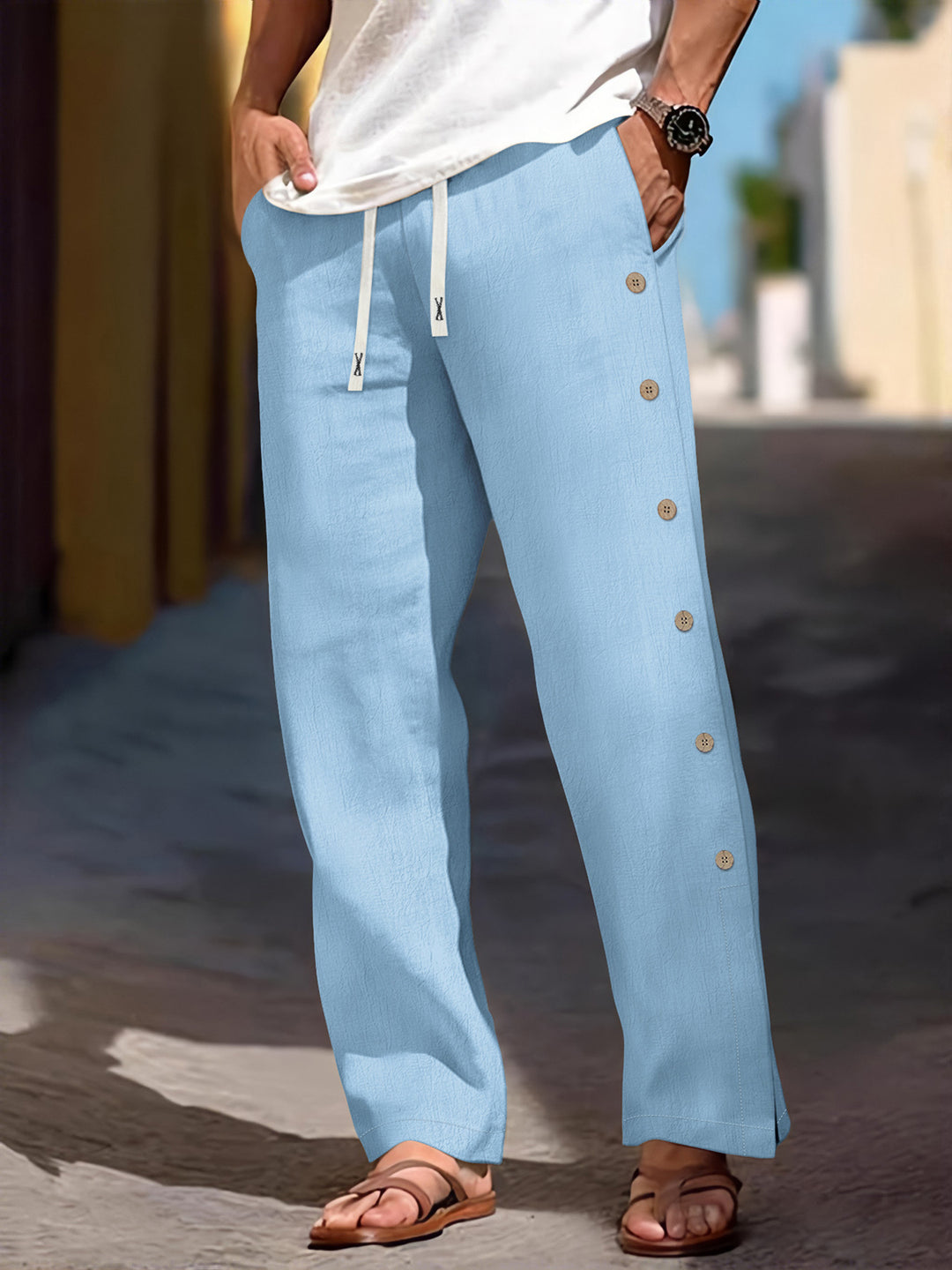 Men's loose leisure pants with side decorative button placket, drawstring waistband, and deep front pockets Mune Fashion