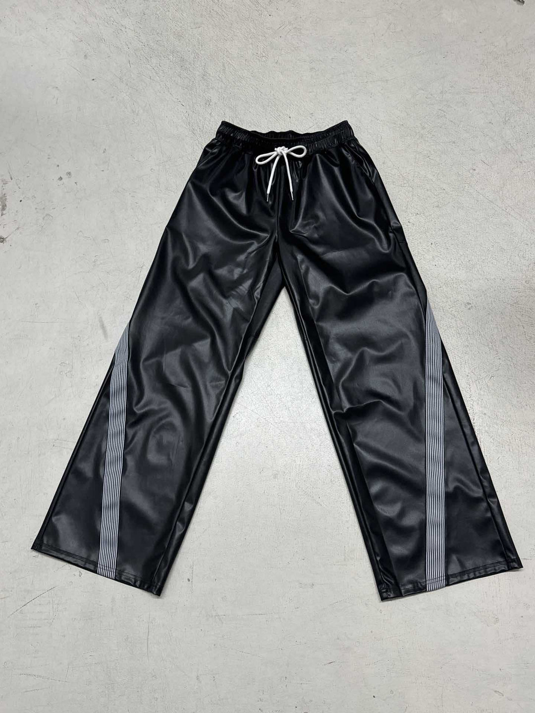 Ladies wide faux leather track pants with elastic waistband, drawstring and side stripes Mune Fashion