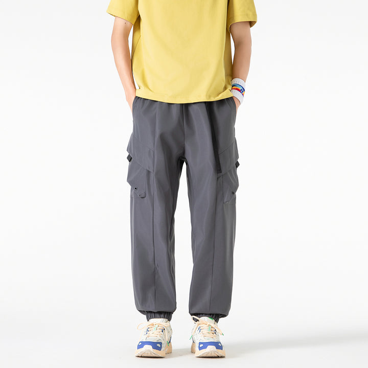 Men's loose cargo jogger pants with elastic drawstring waistband, multiple flap pockets, and ribbed ankles Drune