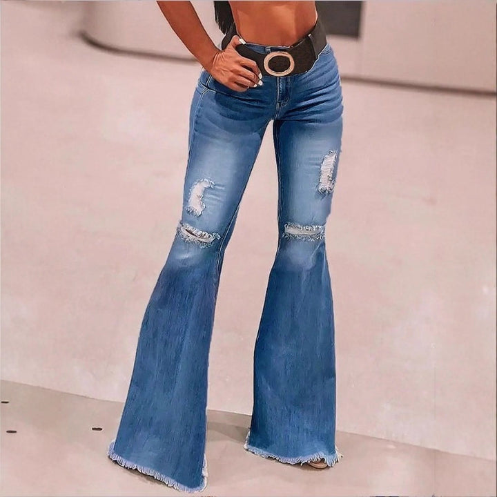 Women high-waisted flared trousers made of stretch denim with flared leg, knee rips, and frayed hem Mune Fashion