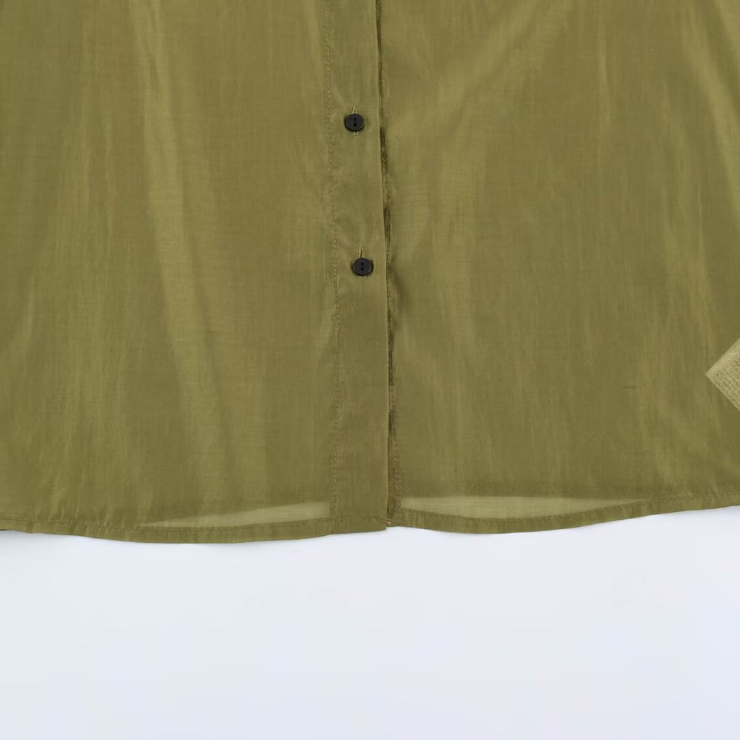 Women's silk effect blouse with voluminous sleeves, layered ruffles, and smocked cuffs