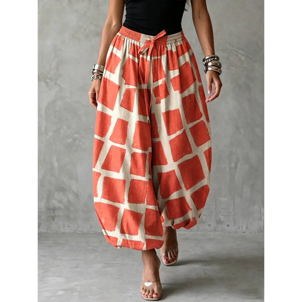 Women's wide harem pants in balloon style with elastic waistband and graphic check pattern Mune Fashion