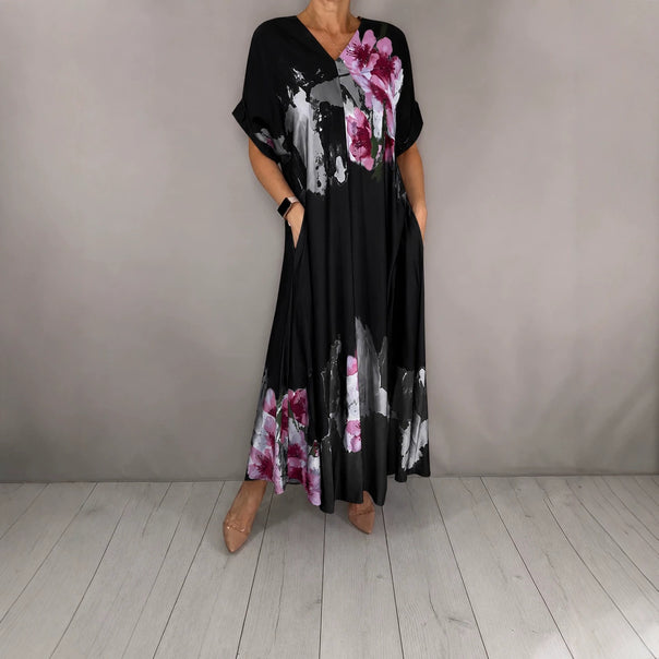 Women's maxi dress with a flowing fall, V-neck, side pockets, and floral watercolor look Mune Fashion