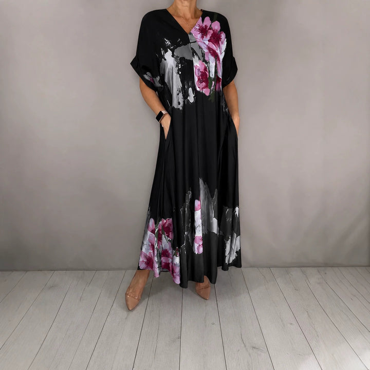Women's maxi dress with a flowing fall, V-neck, side pockets, and floral watercolor look Mune Fashion
