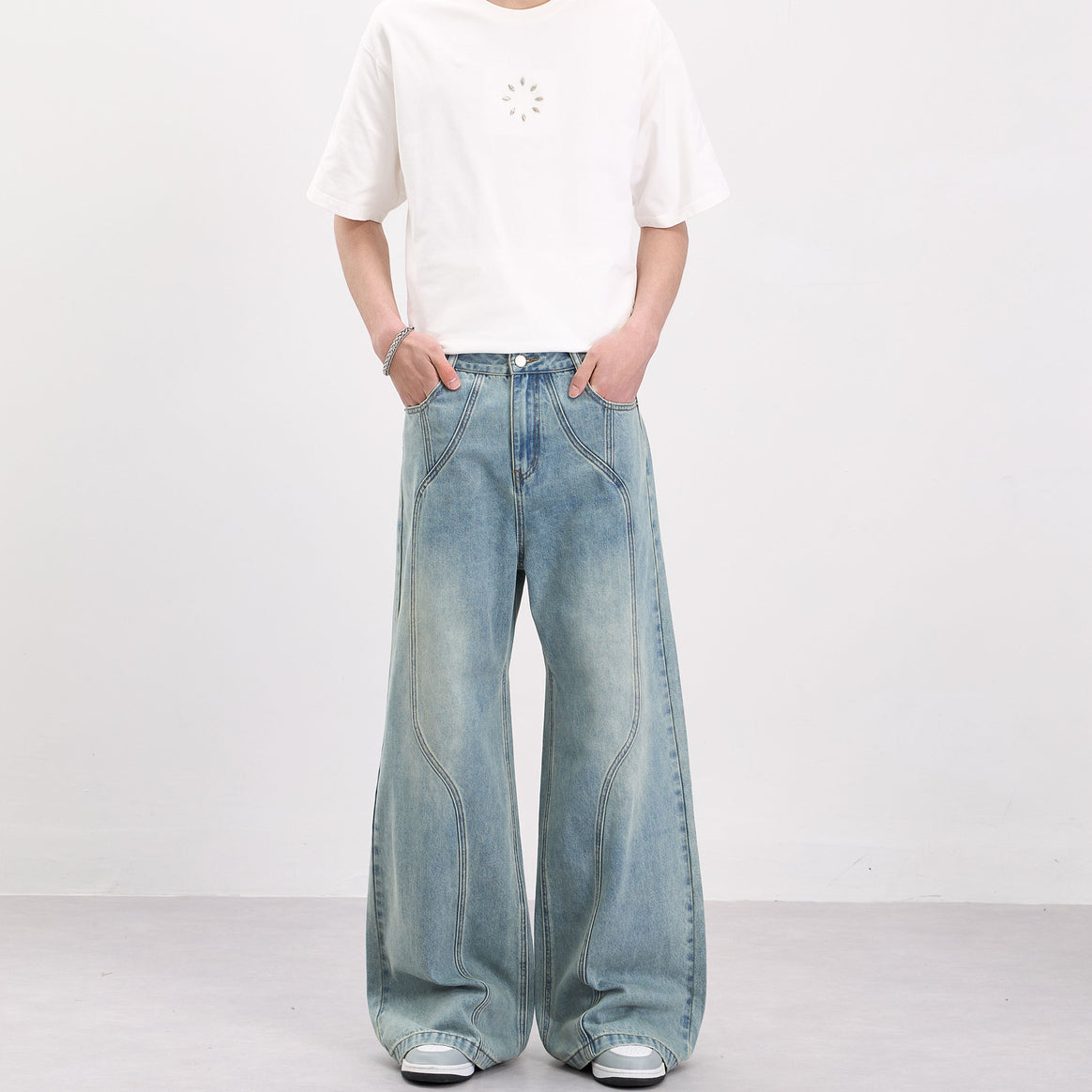 Men's wide-cut denim palazzo pants with curved seam panels and extra-long hem Mune Fashion