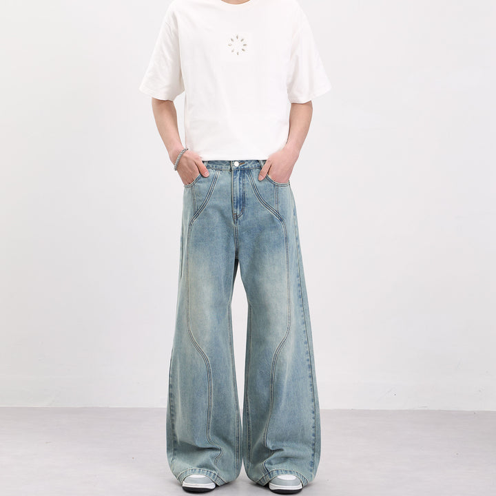 Men's wide-cut denim palazzo pants with curved seam panels and extra-long hem Mune Fashion