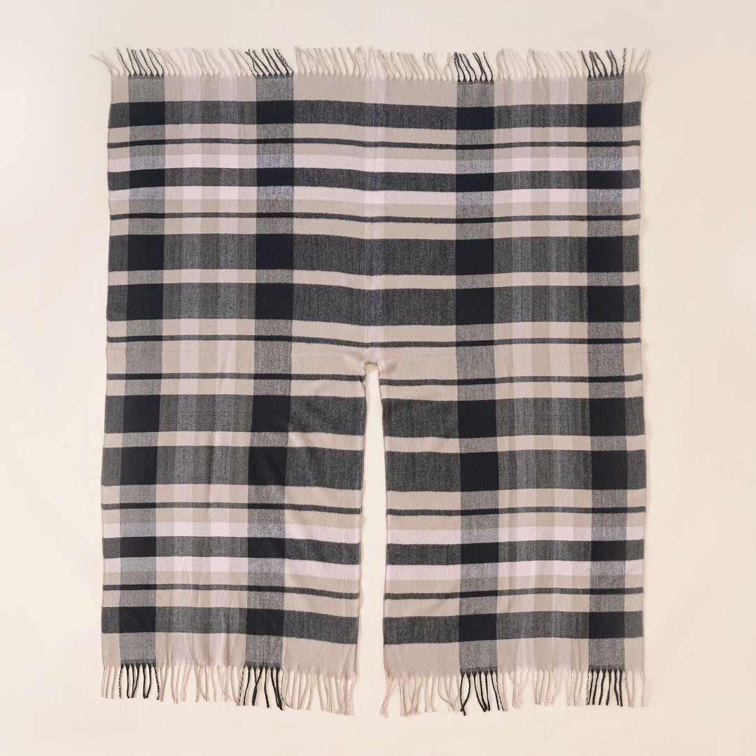 Women's wool blend ruana in boxy oversized with large check pattern and fringed hem.