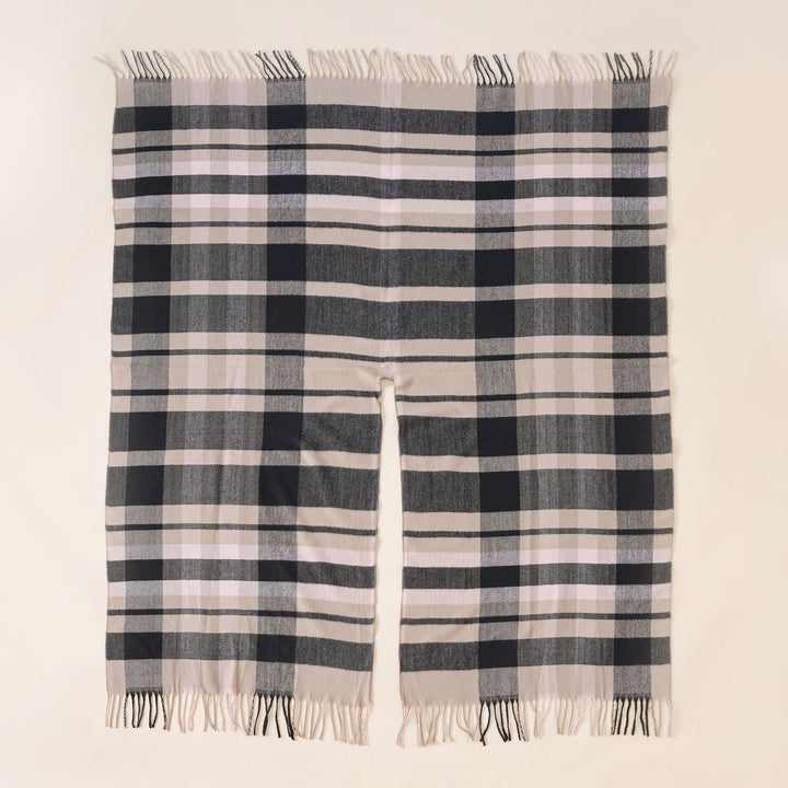Women's wool blend ruana in boxy oversized with large check pattern and fringed hem.